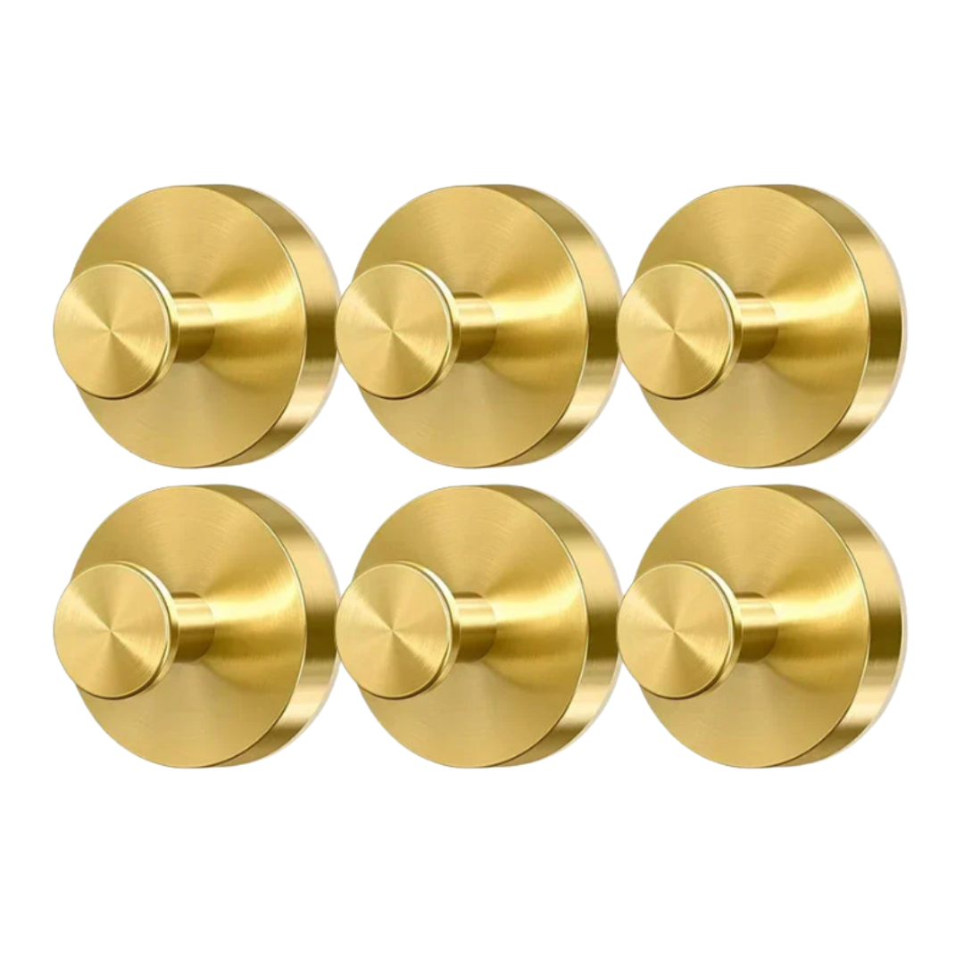 Six gold door knobs on a white background
