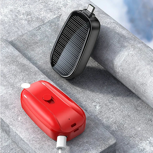 Black and red portable grills on a concrete surface with a blurred natural background